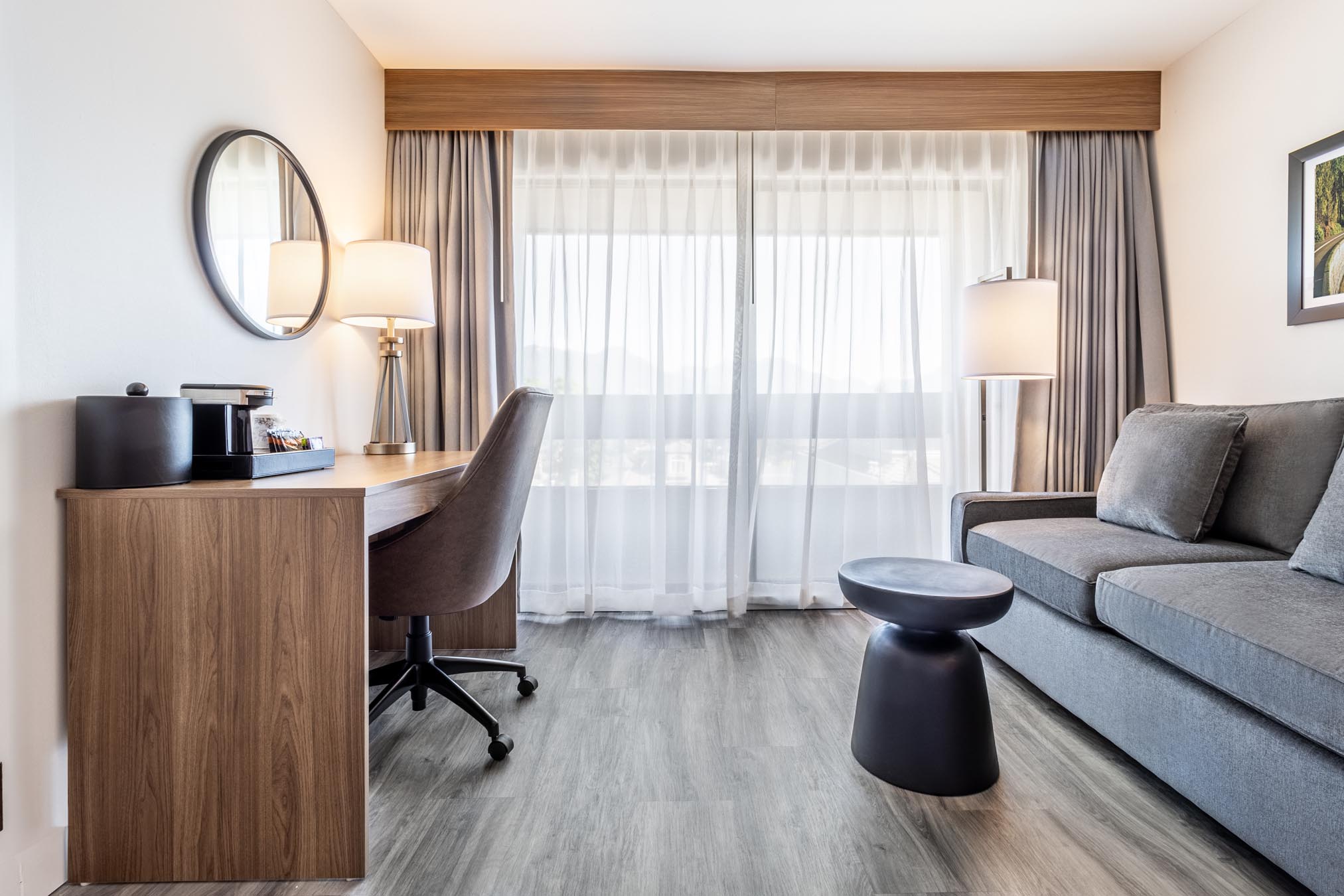 Desk, chair, and sofa in hotel room