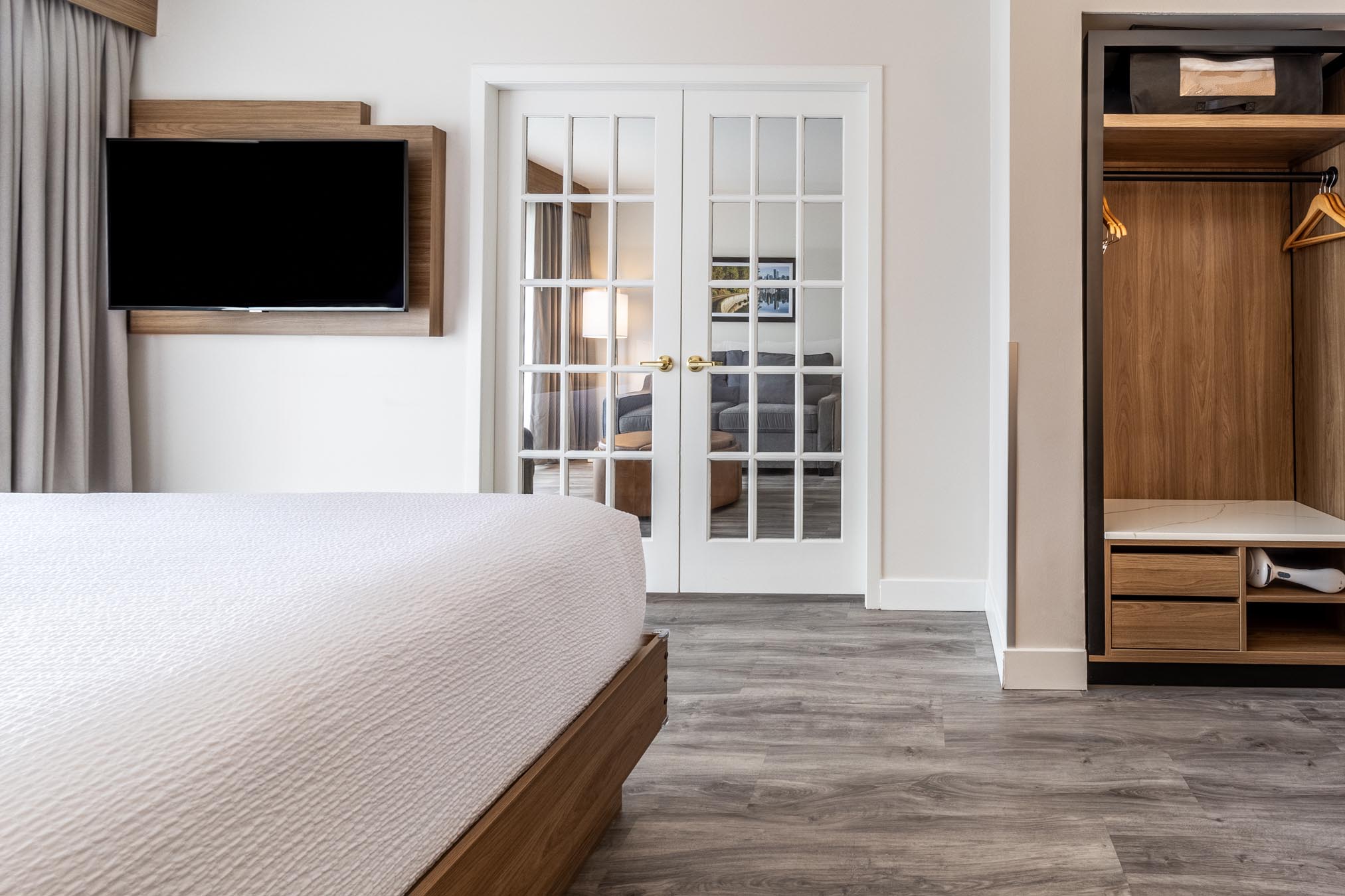 Bed facing tv and french doors