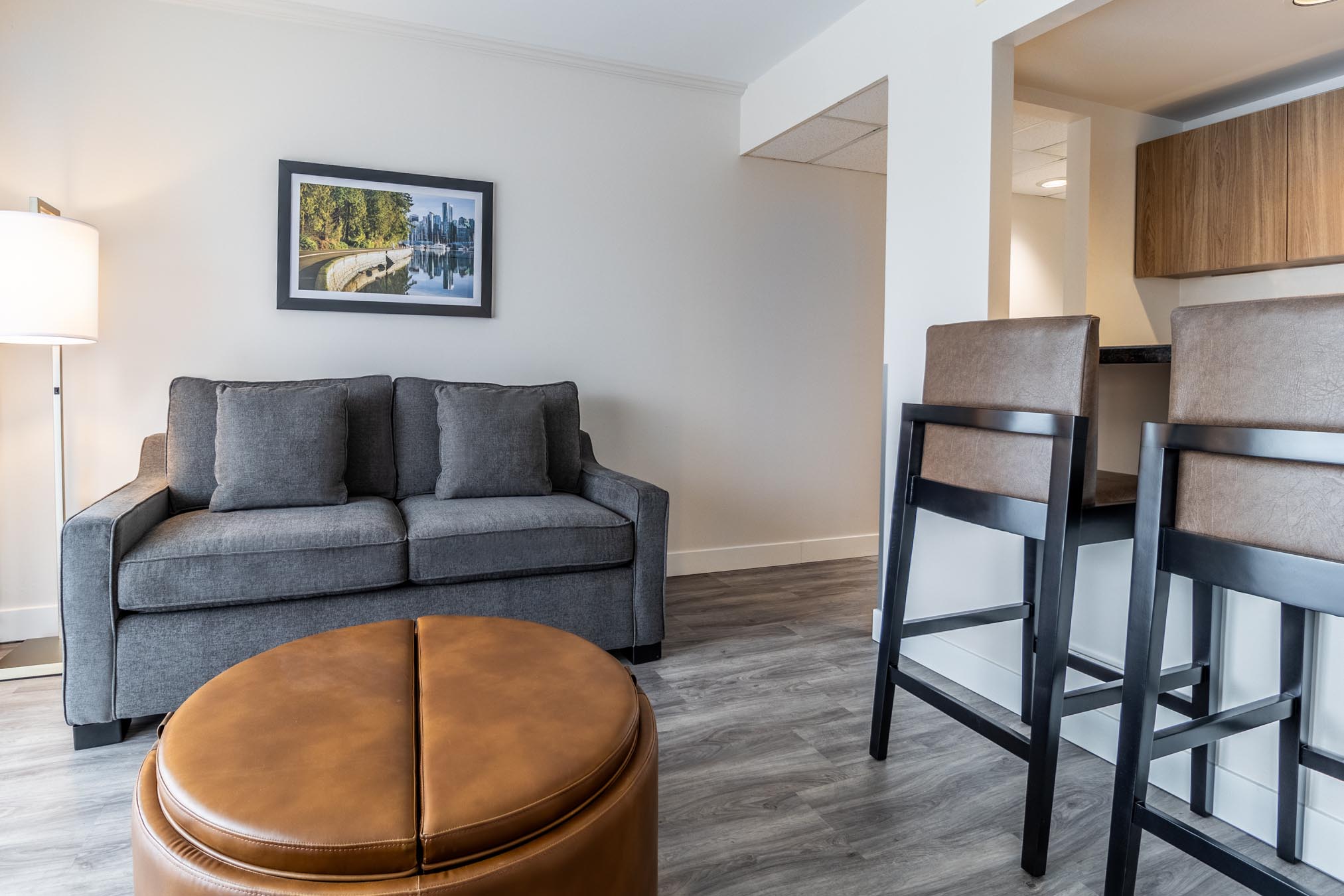 Sofa and coffee table next to counter with chairs