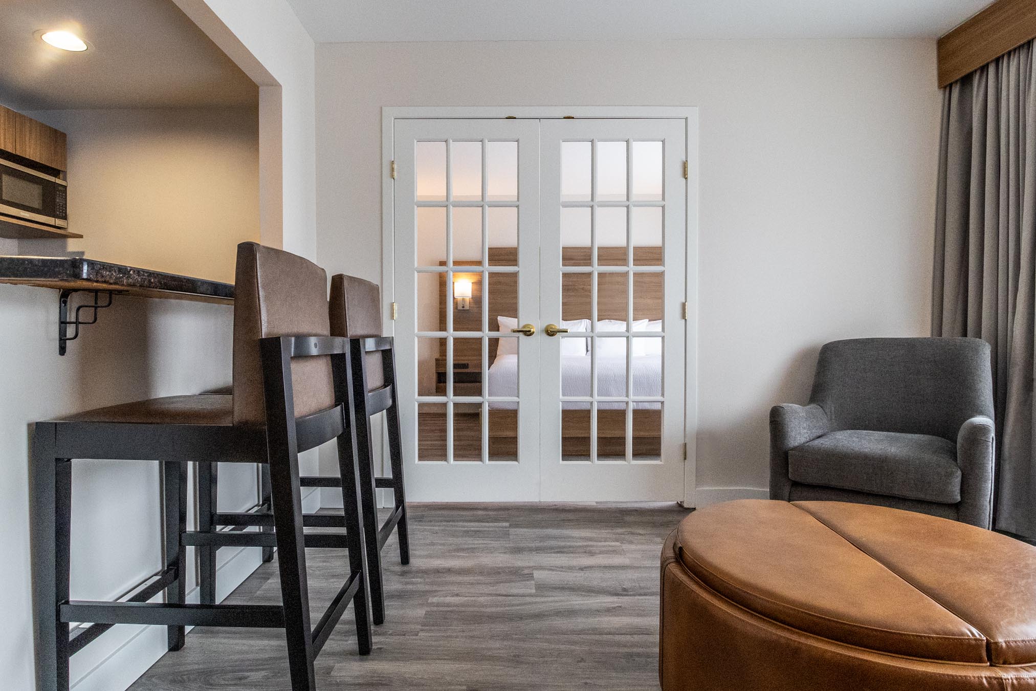 View of living room area and kitchenette in hotel room