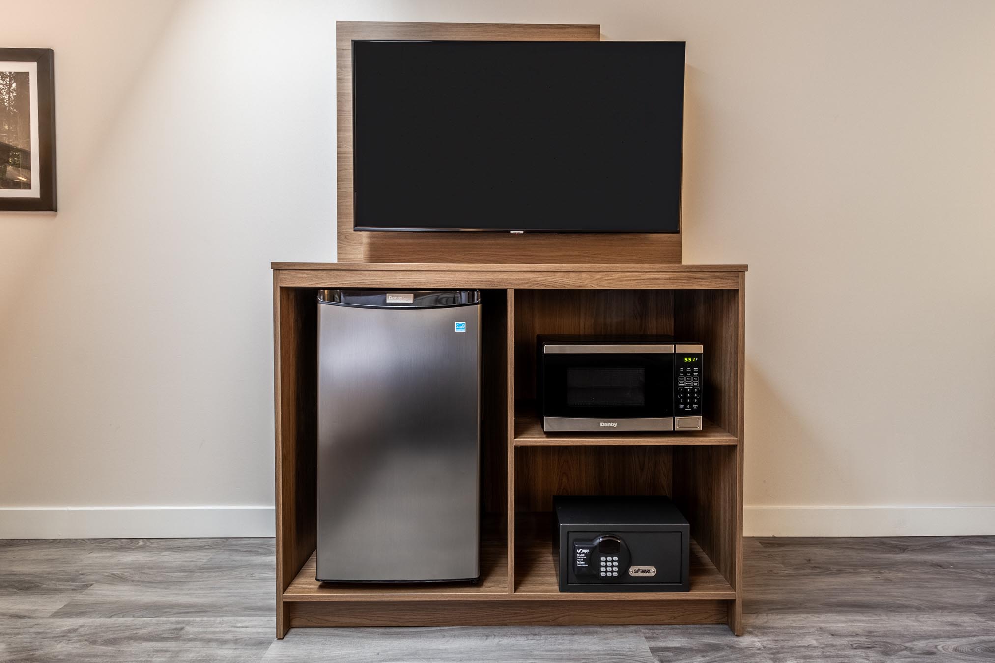 TV and mini fridge in hotel room