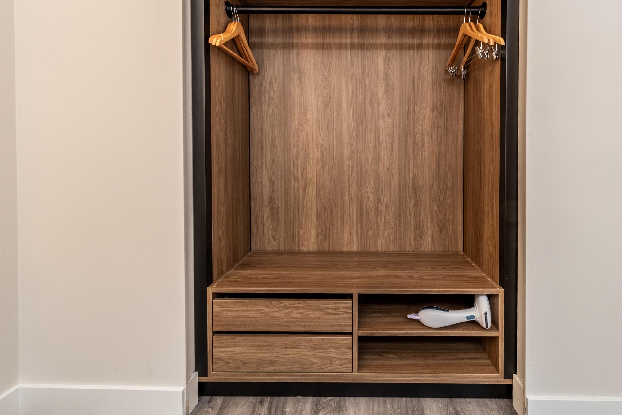 open_concept_closet_with_clothes_steamer_in_the_one_queen_bed_interior_room_at_the_atrium_hotel_vancouver