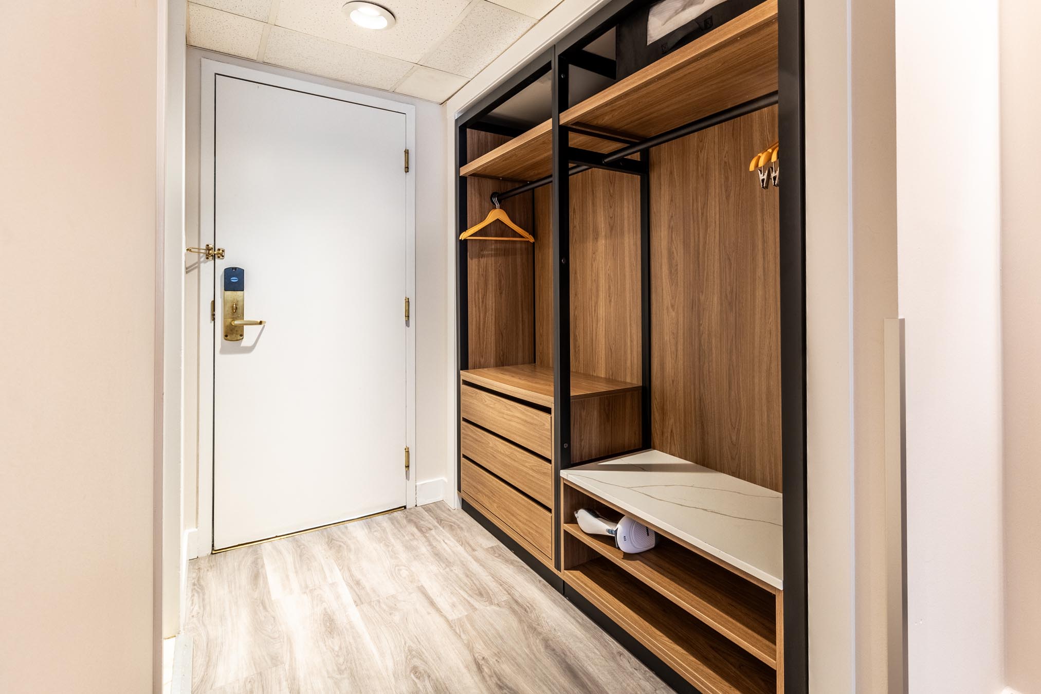 Closet in long hallway in Vancouver hotel room